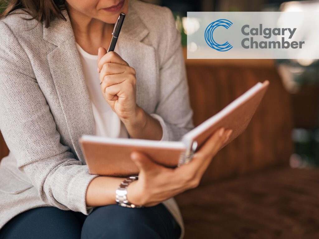 A leader taking the time to rest by writing gin a brown notebook